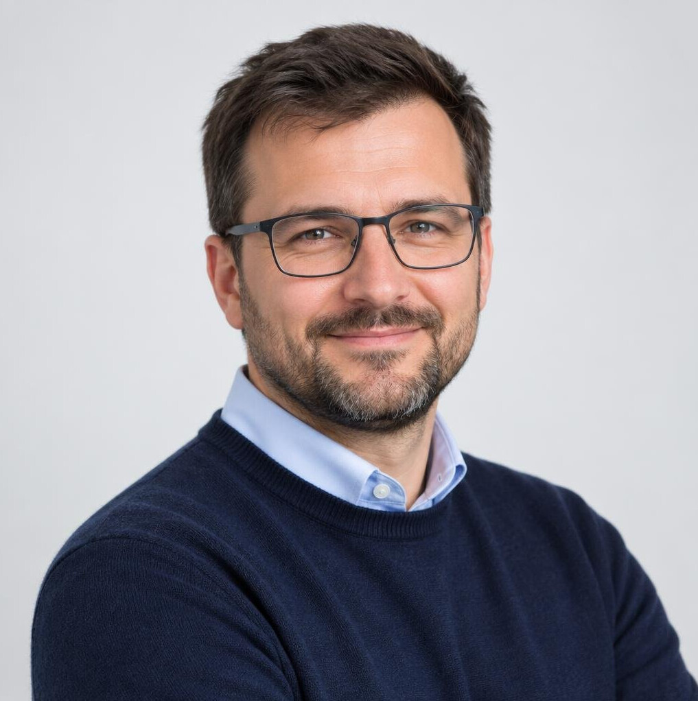 Studio portrait of a Slovenian man software architect with glasses